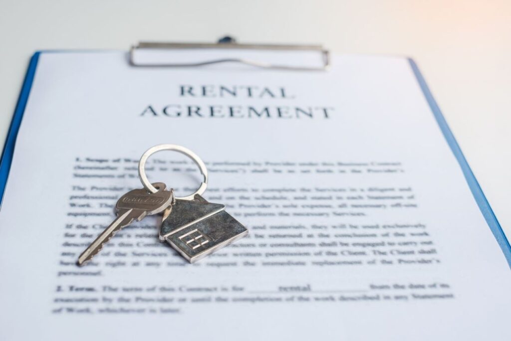 An image of keys on top of a piece of paper titled 'Rental Agreement'