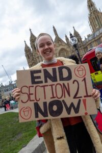 A demonstrator holds a sign that says 'End Section 21 Now!' at the RRC Renters’ Day of Action in May 2023. Credit: Ben Mann